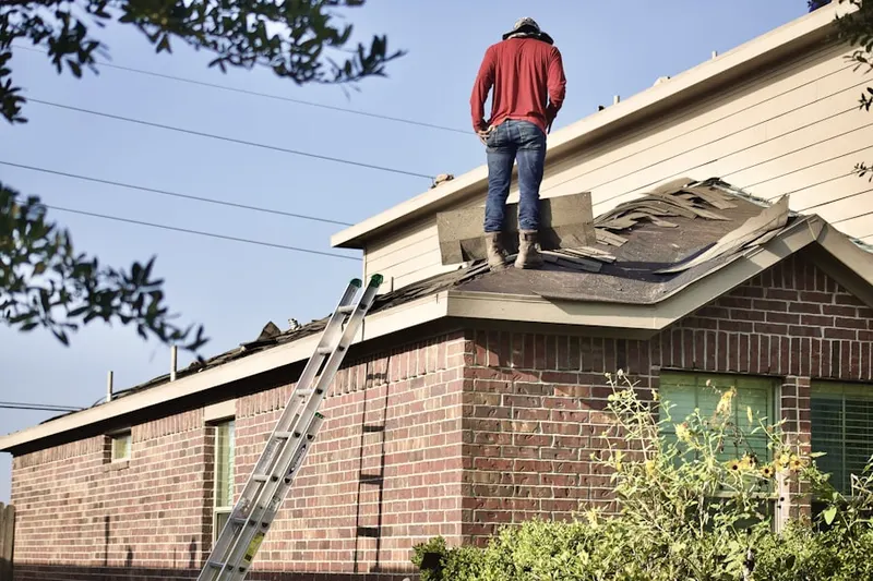 Professional roofer working on a residential roof in Abington Park